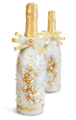 Two decorated wedding champagne bottles isolated on white