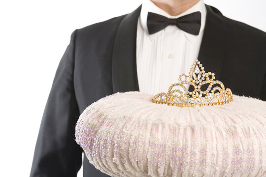Butler Holding a Tiara on a Cushion
