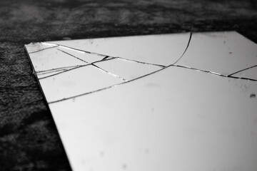 Old and dusty broken mirror on black background.Broken mirror with no reflection.Fractured mirror...