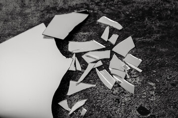 Old and dusty broken mirror on black background.Broken mirror with no reflection.Fractured mirror...