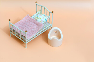 Toy furniture bed and potty. Interior for toys.