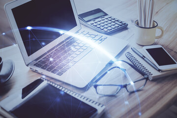 Computer on desktop with social network hologram. Double exposure. Concept of international people connections.