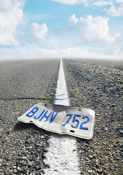 Low Angle View of Bent License Plate on Divided Highway