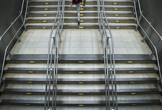 Train station stairs with metal railings at Paddington Station in London, England