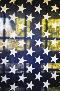 View of translucent American flag on a back porch with window in background