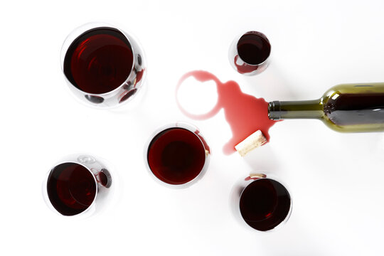 Glasses of Red Wine with Spilled Bottle