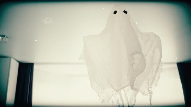Retro frame of a rag ghost flying in a room under the ceiling