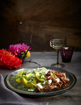 Pork carnitas with herb rice on plate, Mexican Fiesta, studio shot
