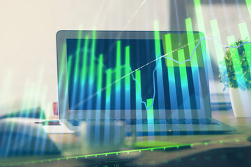 Stock market graph and table with computer background. Double exposure. Concept of financial analysis.