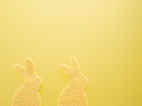 Two Yellow Easter Bunnies Sponges on a Yellow Background