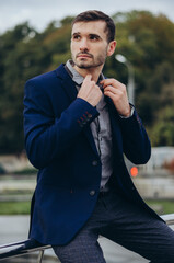 a man in a business suit against the background of the city