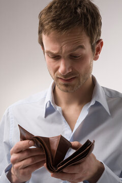 Man Looking in Empty Wallet