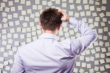 Businessman Looking at a Wall Full of Self Adhesive Notes