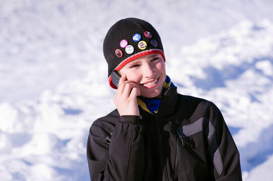 Boy Talking on Cell Phone Outdoors in Winter, Salzburger Land, Austria