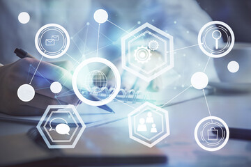 Social network theme hologram over hands taking notes background. Concept of global international people connect. Double exposure