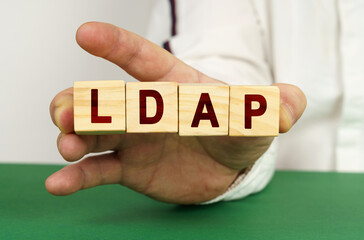 In the man's hand are cubes with the inscription - LDAP
