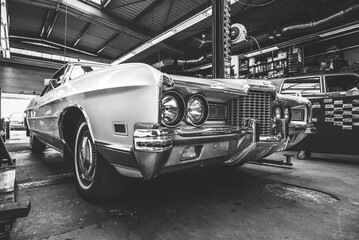 A vintage 1970ies Ford LTD Brougham in a classic car work shop