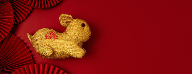 Golden rabbit over red background with paper fans. Text on hare means wishing of fortune, money,...