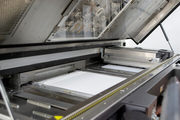 White polyamide powder on working surface of open 3D printer. White polyamide powder in working chamber of open powder 3D printer for industrial use. Modern printing technology. Multi Jet Fusion MJF