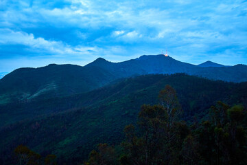 Obraz na płótnie Canvas green mountains in blue hour in rainny day with cloud sky, antenna in top of mountain, sierra de guadalupe state of mexico 