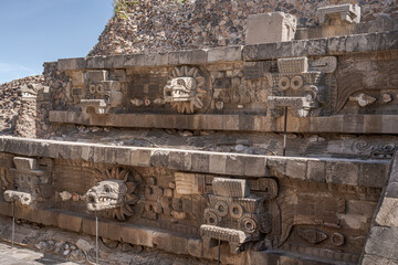 Carved heads depicting feathered snake heads in the Quetzalcoatl temple in Teotihuacan,...