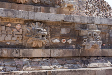 Carved heads depicting feathered snake heads in the Quetzalcoatl temple in Teotihuacan,...