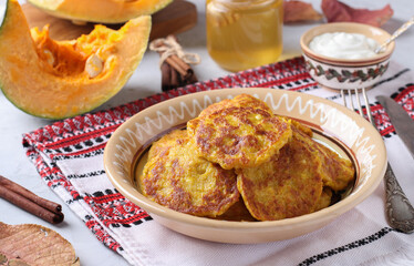 Homemade pumpkin pancakes with curd, served for breakfast with sour cream and honey, Close up