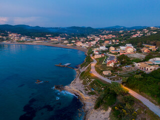 Aerial drone view of Agios Stefanos beach, a small tourist resort on the north east coast of Corfu in Greece 
