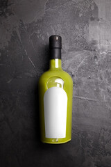 Pistachio Liqueur Cream bottle with blank label on black table. Bottle mockup of Sicilian Pistachio Cremoncello. Creamy liqueur with alcohol content - obrazy, fototapety, plakaty