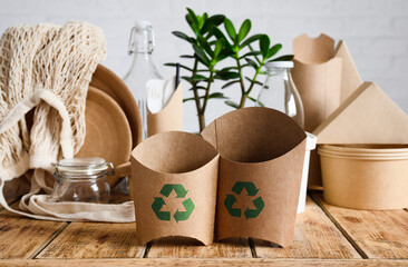 The concept of recycling and biodegradable materials. Eco-friendly paper containers for fast food with a recycling sign.