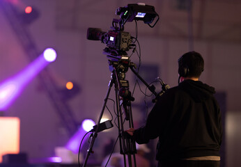 Cameraman working with TV camera at the gaming expo