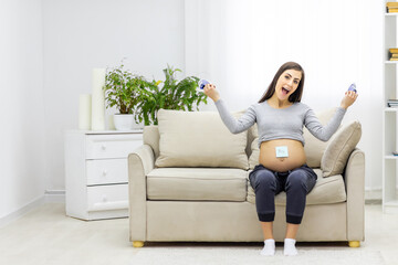 Obraz premium Photo of pregnant woman holding a paper with sex of the child.