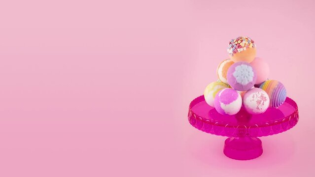 Stop motion bath bombs on a pink tray pink background Vertical frame with place for text