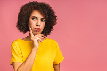 Fototapeta na wymiar Beautiful young african american business woman over isolated pink background thinking about question, pensive expression. Smiling with thoughtful face. Doubt concept.