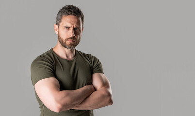 mature muscular guy with stubble wear tshirt, copy space. mature muscular guy isolated on grey