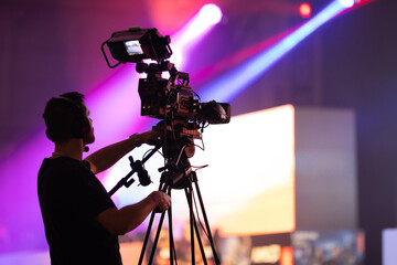The man behind the camera shooting the stage during the gaming festival
