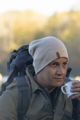 Portrait of traveler man at lake in autumn