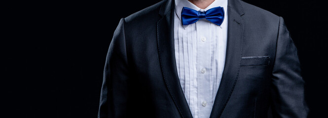 cropped view of tuxedo man with formal bow tie. photo of tuxedo man in formal suit