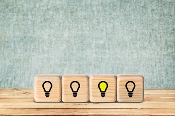 Set of wooden cubes blocks with light-bulb on the desk