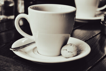  a cup of espresso  coffee served with a cookie on wooden table. Vintage, romantic coffee concept