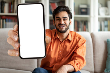 Handsome arab guy showing phone with empty screen, mockup
