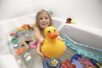 Girl in Bath Holding Rubber Duck