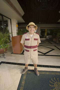 Bellhop Standing in Resort Lobby, Mayan Riviera, Mexico