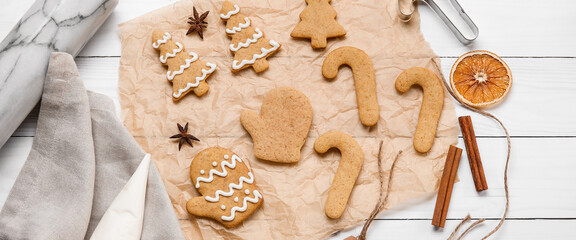 Christmas gingerbread cookies and spices on white wooden background