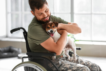 Young soldier in wheelchair with dog at home