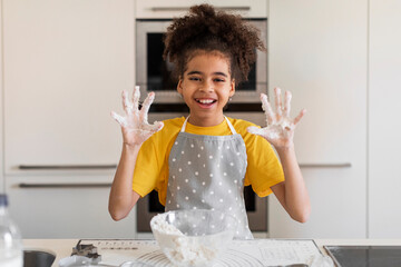 Black Girl Showing Sticky Hands Full Of Dough While Baking In Kitchen