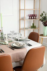 Dinnerware and eucalyptus branches on served table