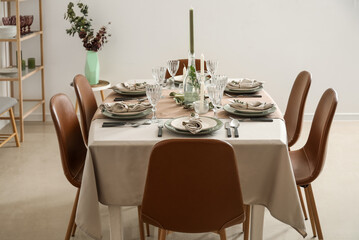 Beautiful setting with eucalyptus branches on served table in light room