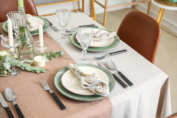 Dinnerware and eucalyptus branches on served table