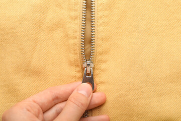 Closeup view of woman zipping clothes